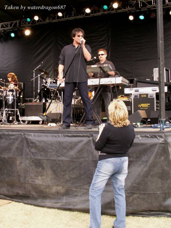 Jimi Jamison, Joe Lynn Turner, and Lane Hoppen live in Cheyenne, Wyoming, 24 June, 2006 (with Sally Irwin looking on). Photo copyright waterdragon687; not to be reproduced without permission.