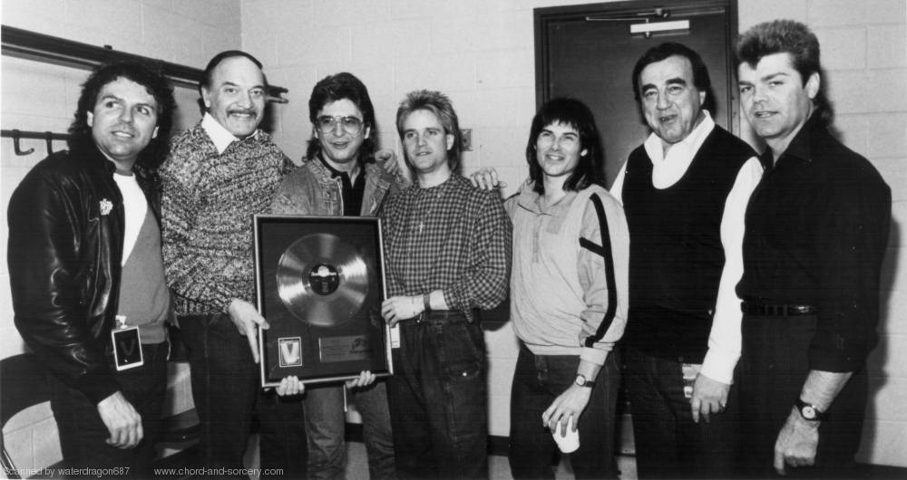 Survivor, circa 1984, being awarded a gold album for VITAL SIGNS; from a Scotti Bros. promotional photo